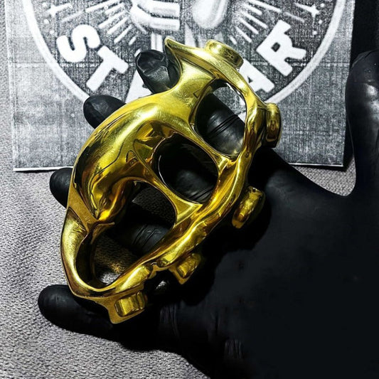 A creative solid brass four-finger knuckle duster in a classic English silhouette