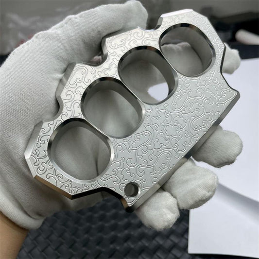 Steel knuckle duster with engraved decorative pattern