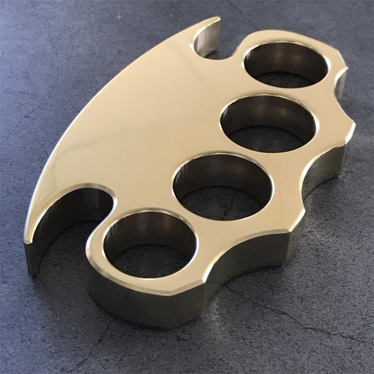 A finely polished brass knuckle duster shown as a display-centre piece