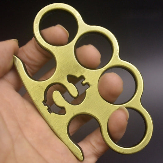 Brass knuckle duster showing rich natural patina with darker recesses and lighter high points