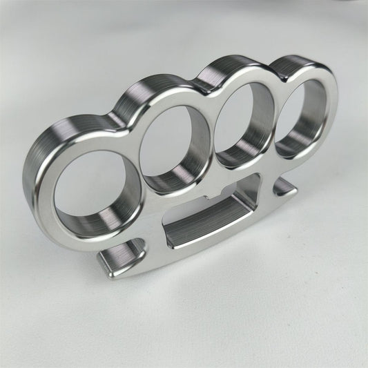 Mirror-polished stainless steel four-finger knuckle duster showing CNC machining precision