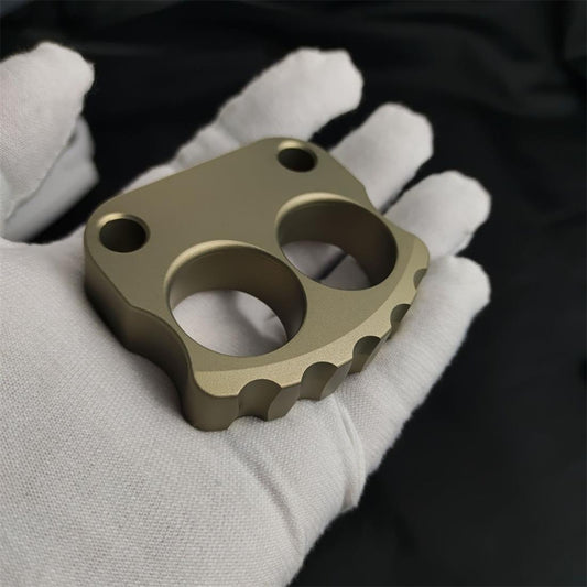 A thickened two-finger aluminium knuckle duster, a compact shape variant