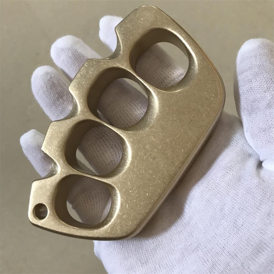A creative solid brass knuckle duster with aged tone, useful when comparing old and new