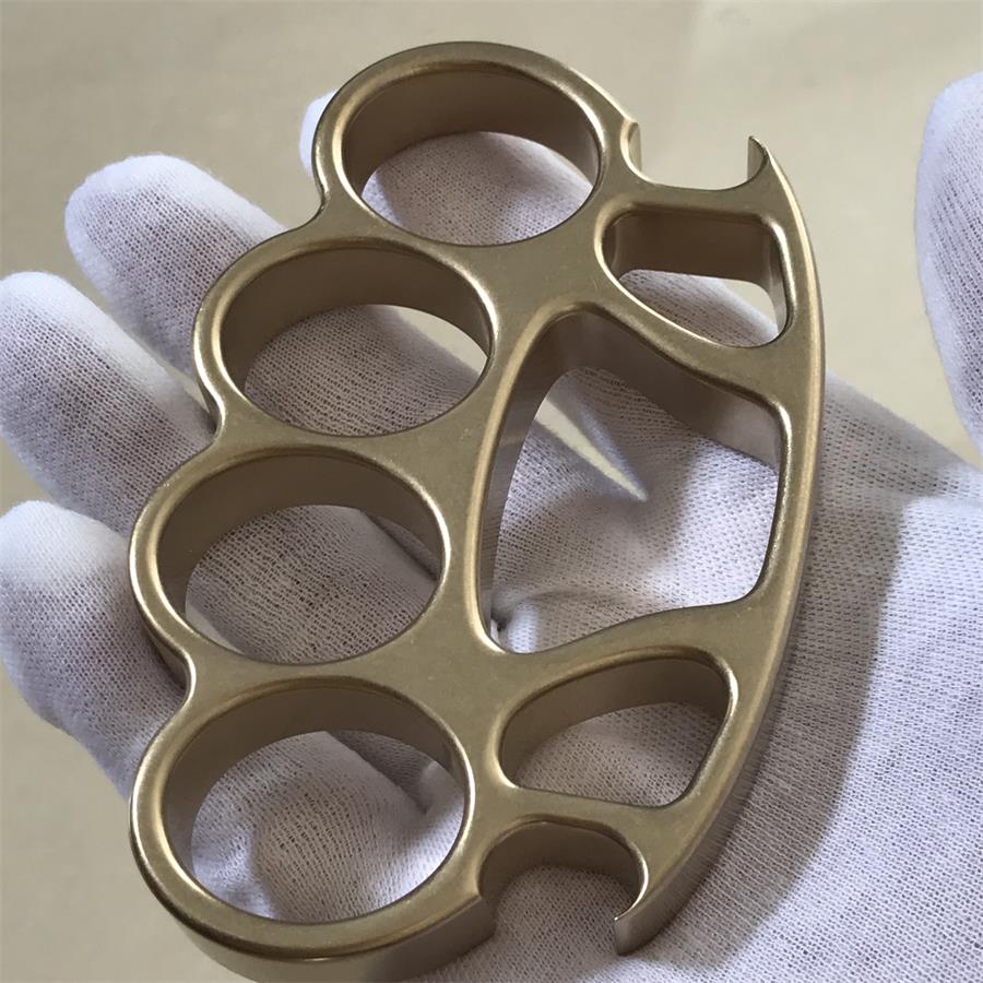 A stonewashed solid brass knuckle duster, illustrating warm brass tone against steel