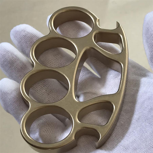 A stonewashed solid brass knuckle duster, illustrating warm brass tone against steel