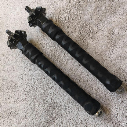 Two chain hammers laid parallel showing full length grip and spiked hammer heads