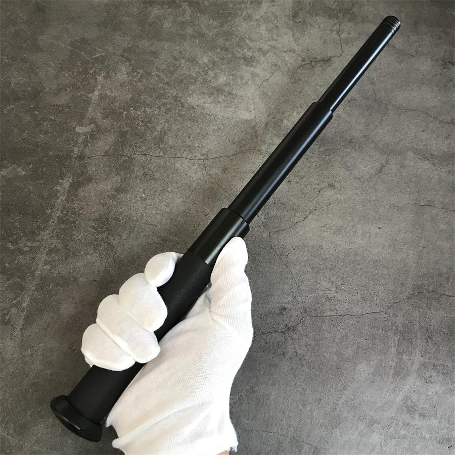 Expandable telescopic baton extended in hand showing rubber grip
