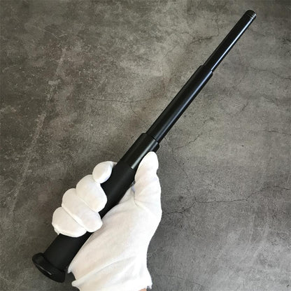 Expandable telescopic baton extended in hand showing rubber grip